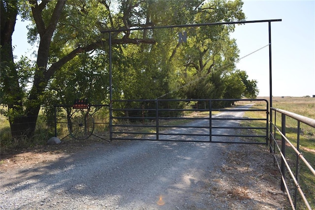 view of gate with a rural view