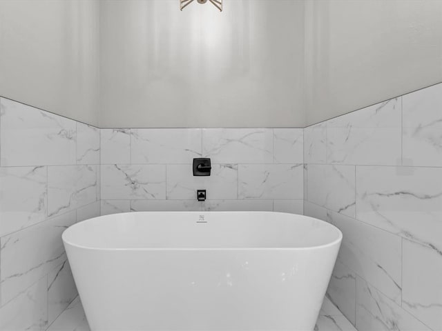 bathroom featuring a tub and tile walls