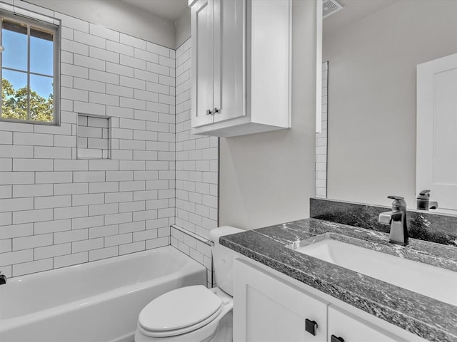 full bathroom with vanity, toilet, and tiled shower / bath