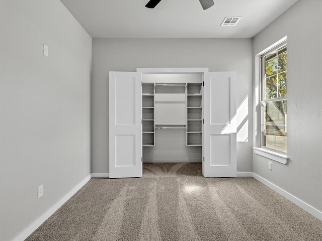 interior space with ceiling fan, a closet, and carpet