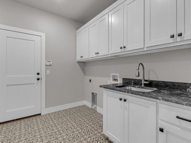 laundry room with cabinets, washer hookup, electric dryer hookup, sink, and light tile patterned floors