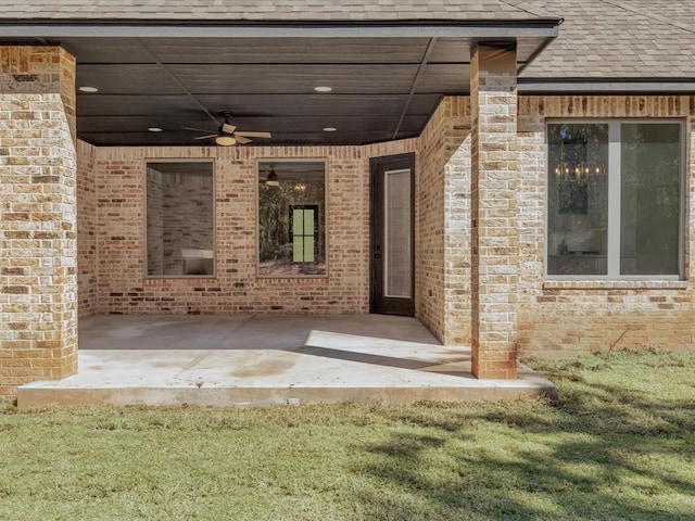 entrance to property with a patio and ceiling fan