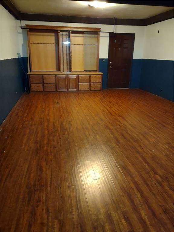 spare room with dark wood-style flooring