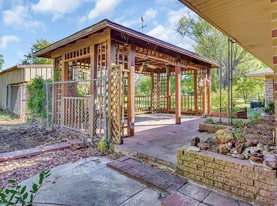 view of patio featuring an outbuilding