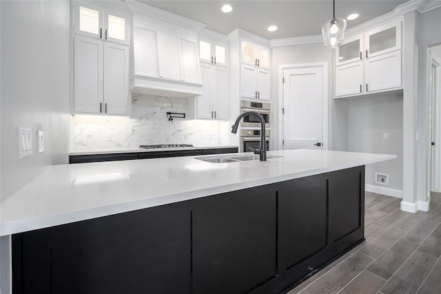 kitchen featuring backsplash, stainless steel appliances, dark wood-type flooring, pendant lighting, and white cabinets