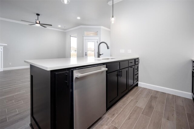 kitchen with dishwasher, light wood-type flooring, ornamental molding, and sink