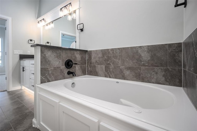 bathroom featuring tile patterned flooring, vanity, and a washtub