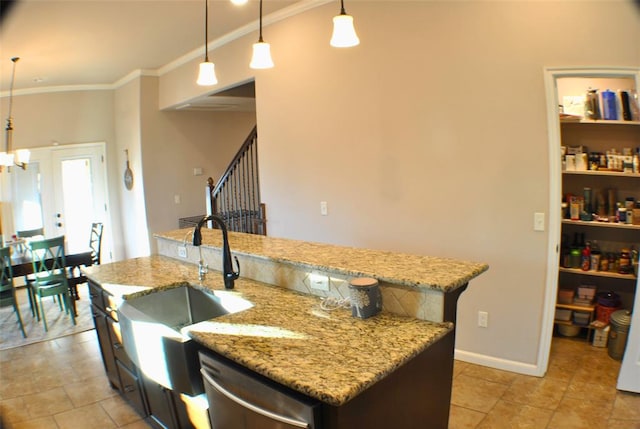 kitchen with a kitchen island with sink, sink, pendant lighting, and stainless steel dishwasher