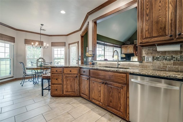 kitchen with a sink, a healthy amount of sunlight, backsplash, and dishwasher