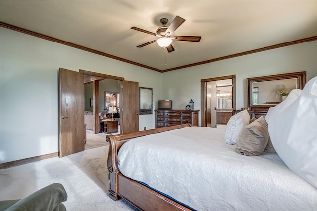 carpeted bedroom with crown molding, a ceiling fan, baseboards, and ensuite bathroom