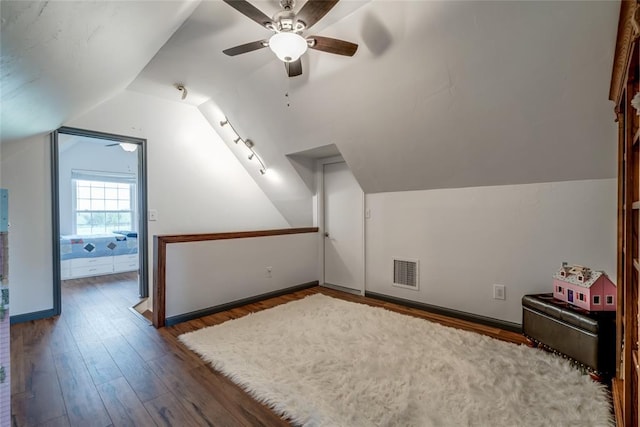 bonus room with a ceiling fan, vaulted ceiling, wood finished floors, and visible vents