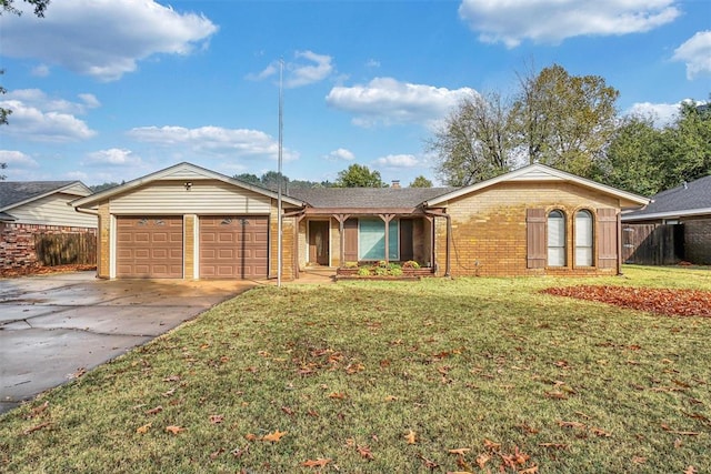 ranch-style home featuring a garage, brick siding, concrete driveway, fence, and a front yard