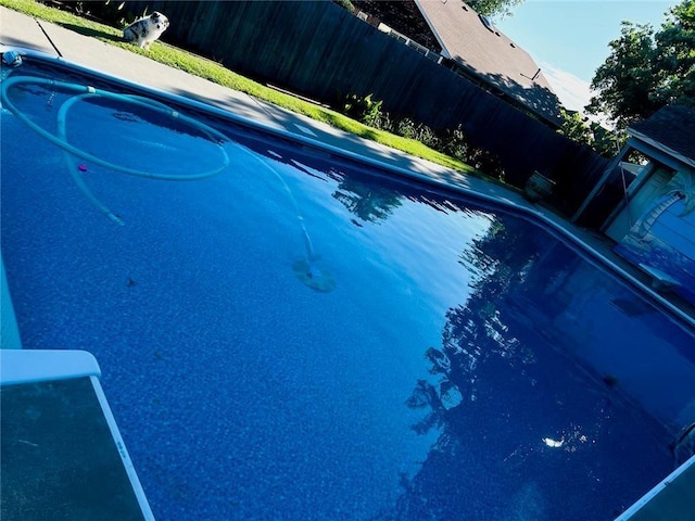 view of swimming pool featuring a fenced in pool and fence