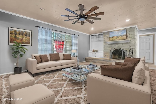 living room featuring ceiling fan, ornamental molding, a fireplace, and carpet