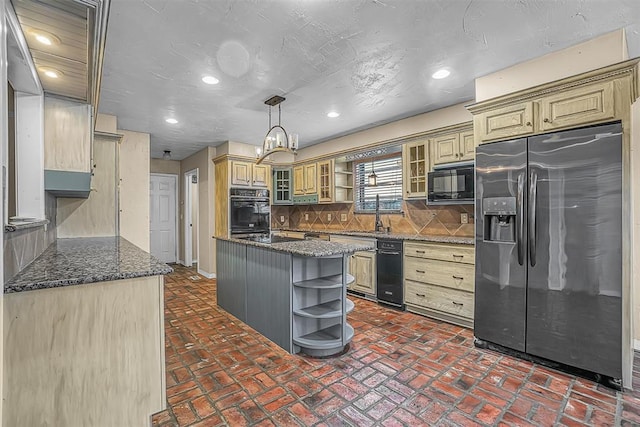 kitchen with glass insert cabinets, decorative light fixtures, black appliances, open shelves, and backsplash