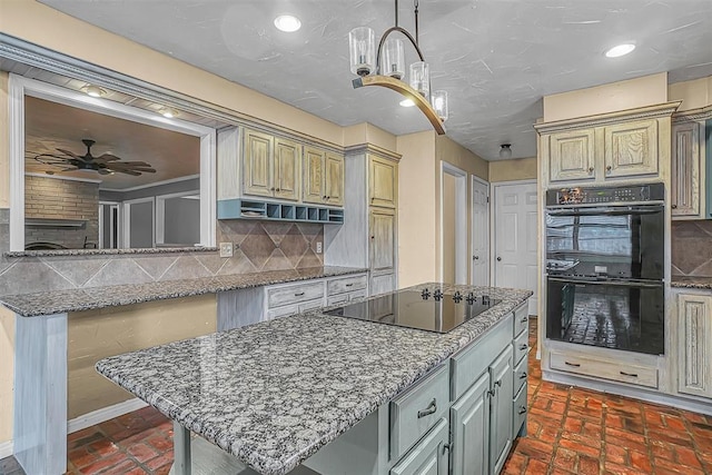 kitchen featuring ceiling fan, brick floor, a center island, black appliances, and tasteful backsplash