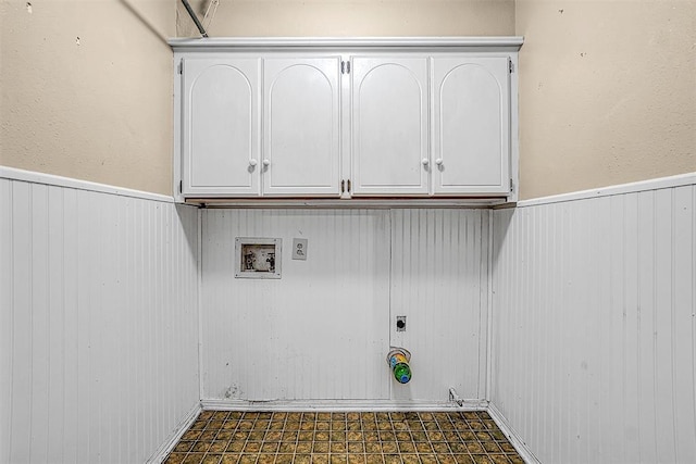 laundry area featuring washer hookup, a wainscoted wall, gas dryer hookup, and dark floors