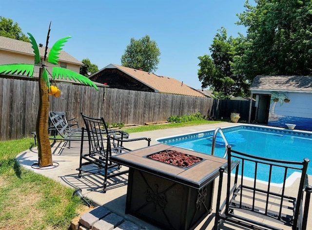 view of pool featuring a fire pit, a diving board, a fenced backyard, and a fenced in pool