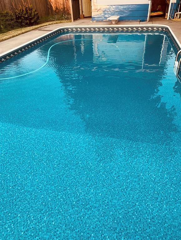 outdoor pool featuring fence