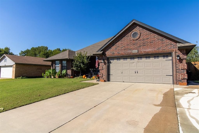 view of front of house featuring a garage and a front lawn