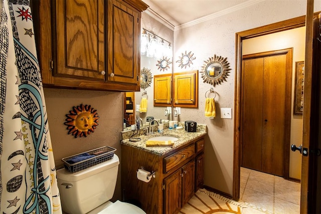 bathroom featuring tile patterned floors, vanity, toilet, and crown molding