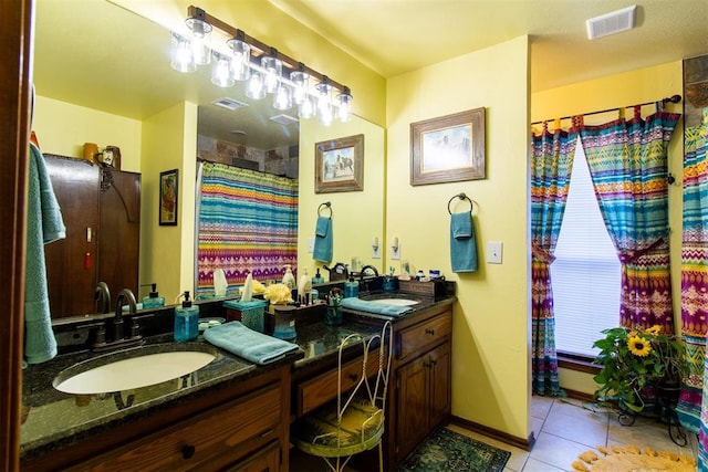 bathroom featuring tile patterned flooring and vanity