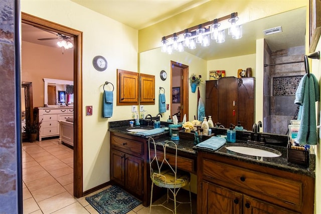 bathroom with tile patterned flooring, vanity, and ceiling fan