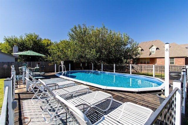 view of swimming pool with a wooden deck