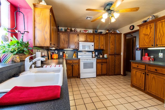 kitchen with white appliances, sink, ceiling fan, decorative backsplash, and light tile patterned floors