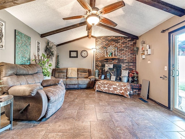 living room with vaulted ceiling with beams, a textured ceiling, and plenty of natural light