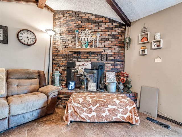 living room with lofted ceiling with beams and a textured ceiling