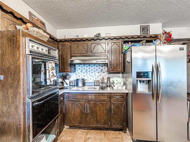 kitchen featuring dark brown cabinets, a textured ceiling, range hood, and black appliances