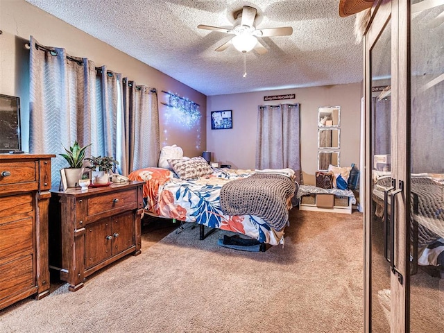 carpeted bedroom with ceiling fan and a textured ceiling