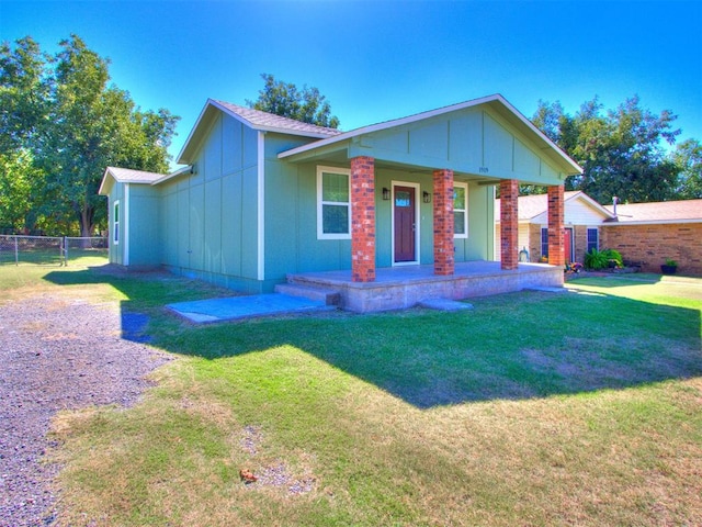 view of front facade featuring covered porch and a front yard