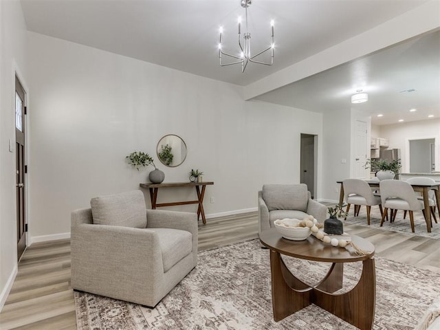 living room with a notable chandelier and light wood-type flooring