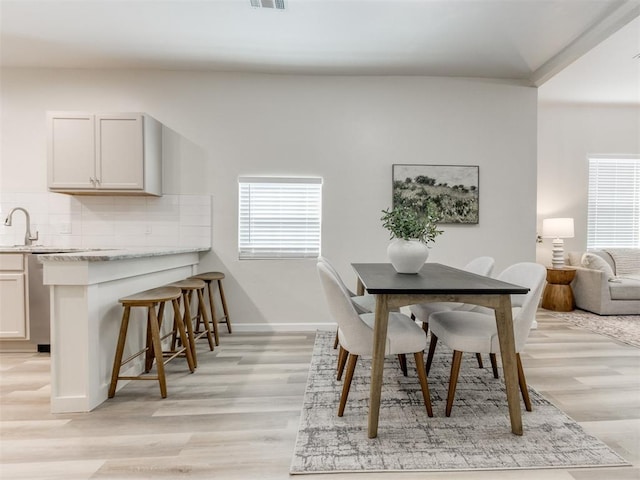 dining space with light wood-type flooring