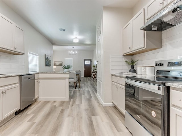 kitchen featuring appliances with stainless steel finishes, light wood-type flooring, white cabinetry, and plenty of natural light