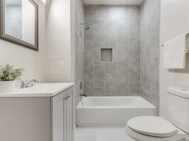 full bathroom with tile patterned flooring, vanity, toilet, and tiled shower / bath combo