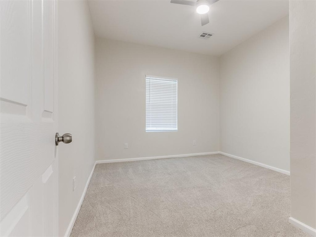 unfurnished room featuring ceiling fan and light colored carpet