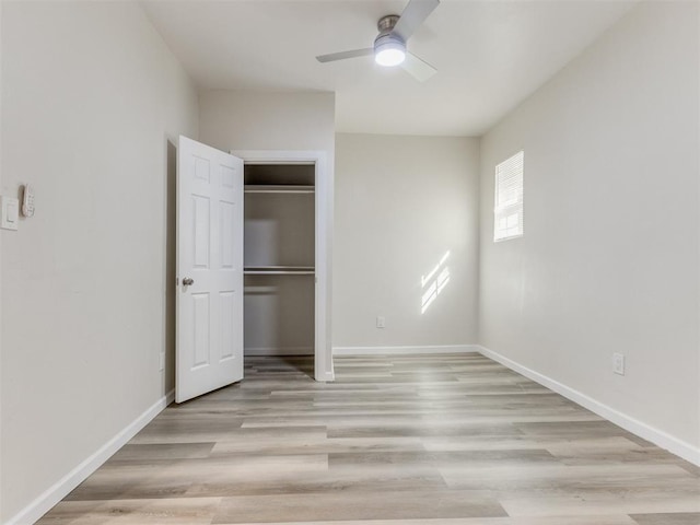 unfurnished bedroom with light wood-type flooring, a closet, and ceiling fan