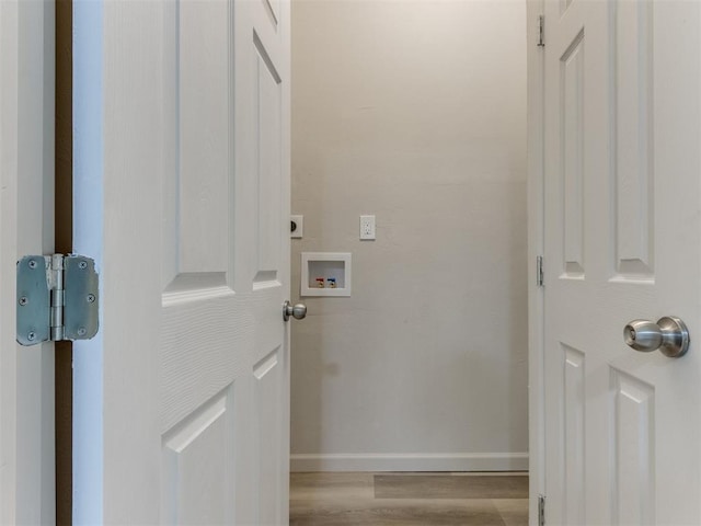 laundry area featuring electric dryer hookup, hookup for a washing machine, and light hardwood / wood-style floors