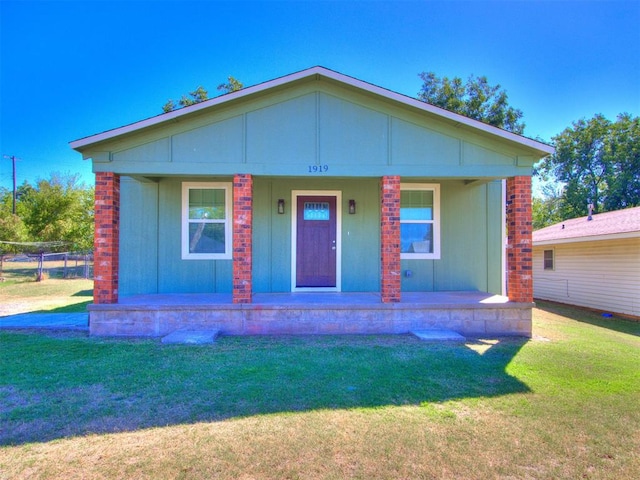 view of front of home with covered porch and a front yard