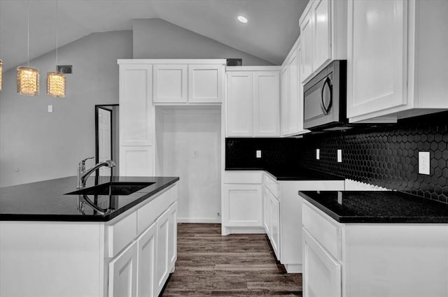 kitchen featuring white cabinets, backsplash, and sink