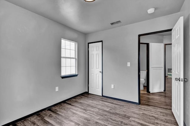 unfurnished bedroom featuring hardwood / wood-style flooring