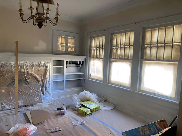 unfurnished dining area with a chandelier and crown molding