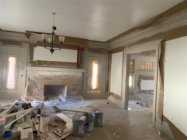 misc room featuring a notable chandelier, plenty of natural light, and a fireplace