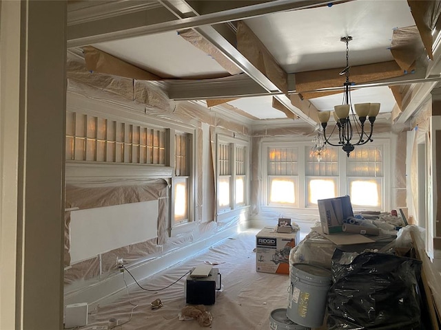 unfurnished sunroom with beamed ceiling, an inviting chandelier, and coffered ceiling