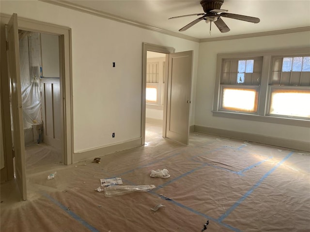 unfurnished room featuring ceiling fan and crown molding