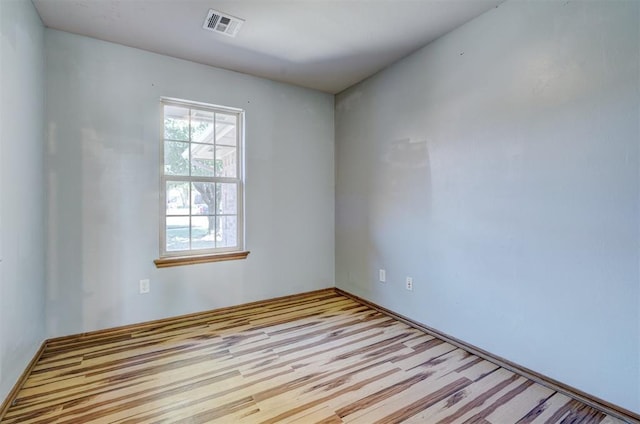 empty room with light hardwood / wood-style flooring