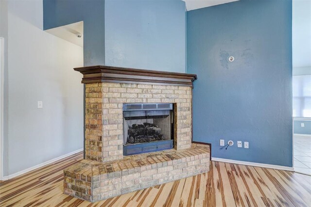 room details with hardwood / wood-style floors and a fireplace